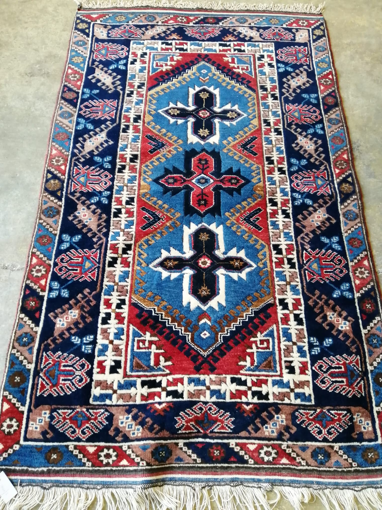 A Caucasian blue ground rug, 200 x 118cm